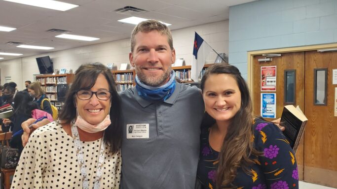 NY Times Bestselling Author, Charles Martin, visits Providence and poses for a picture in a library.