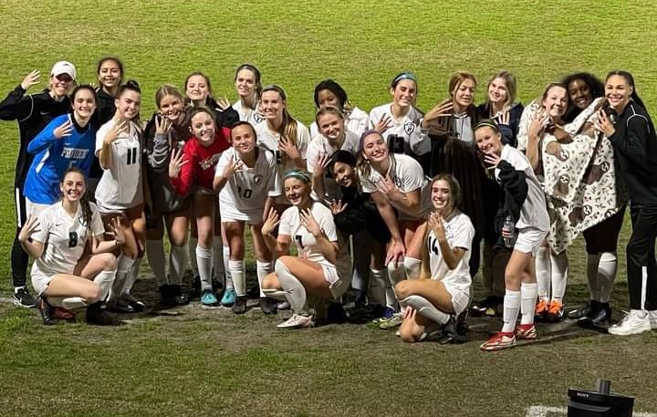 A group of soccer players headed to the Final Four posing for a picture.