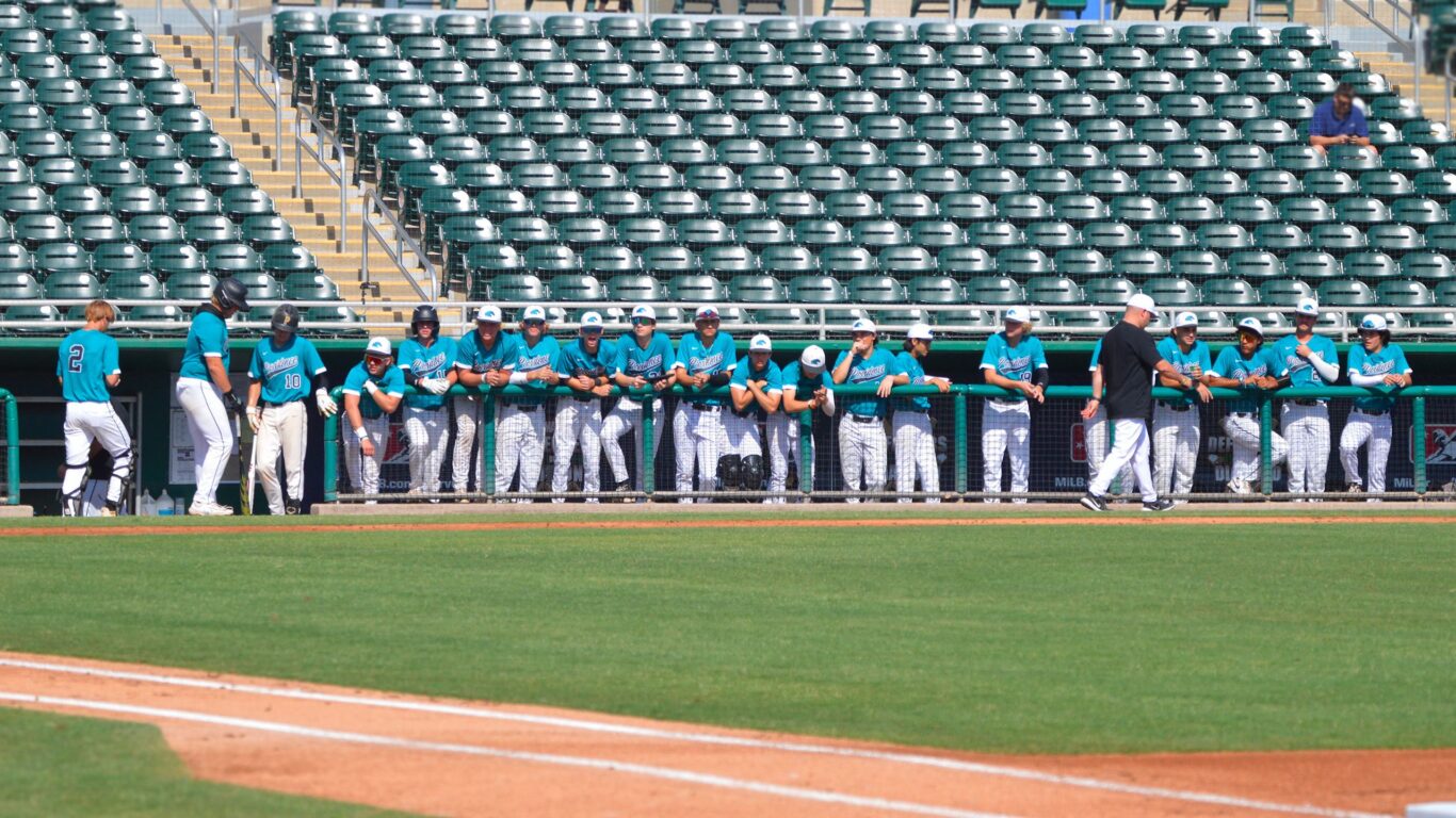 A group of baseball players standing on a field, playing the sport they love.