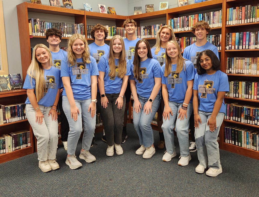 Providence NHS Distinguished Scholars from the class of 2023-2024 posing for a photo in a library.