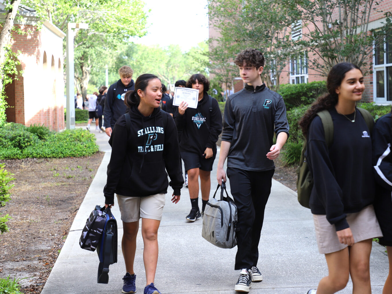 A group of admissions students walking down a sidewalk.