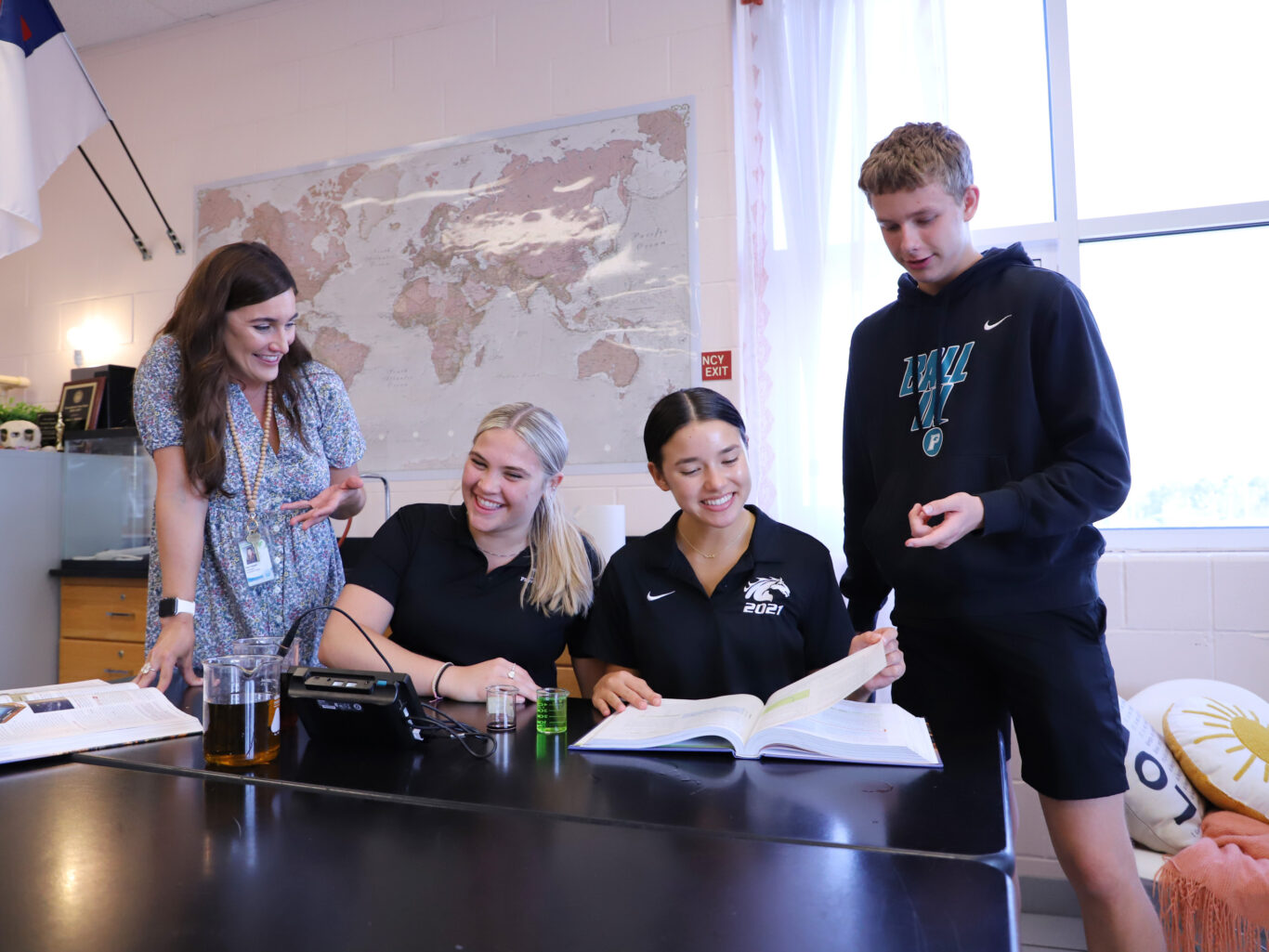 A group of people engaged in initiatives, standing around a table.