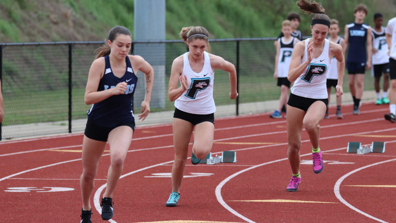 A group of girls participating in a corporate-sponsored track event.