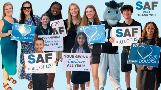 A group of people holding signs that say SAF.