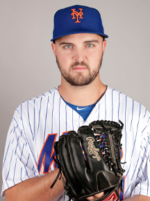 A college baseball player holding a mitt in front of a camera.