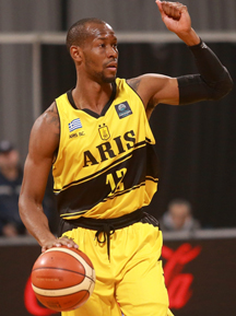 A Pro Athlete in a yellow uniform holding a ball.