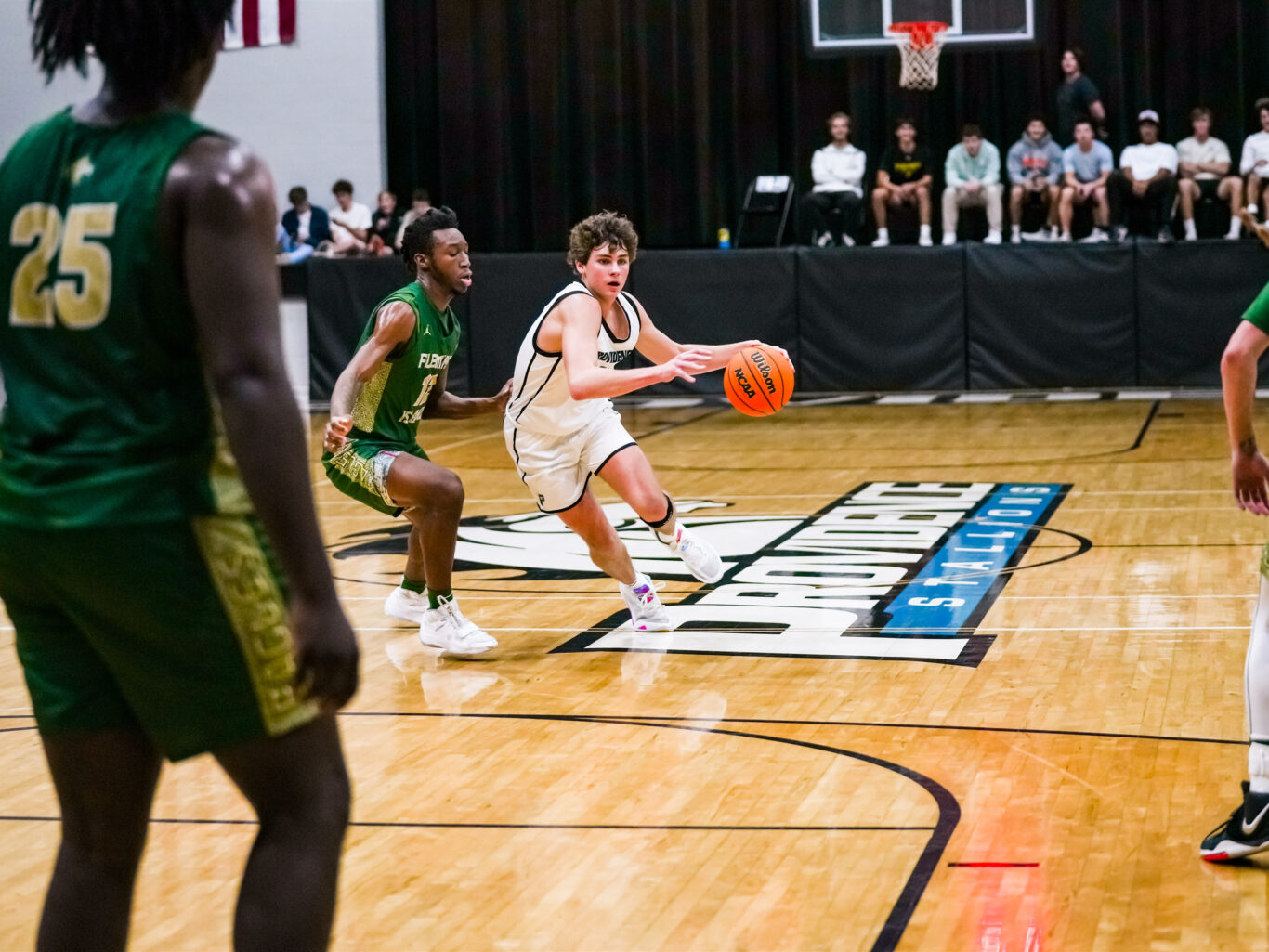 A group of boys playing basketball on a court.