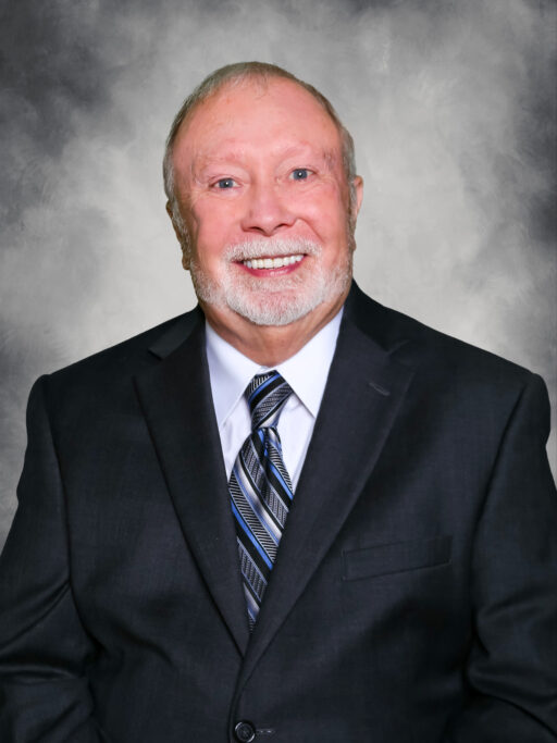 A man in a suit and tie poses for a historical photo.