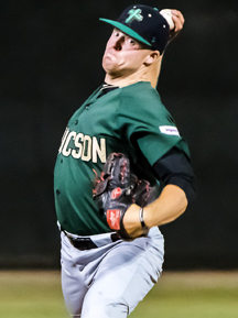 A pro baseball player is pitching a ball during a game.