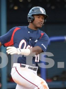 A pro baseball player is running on a field.