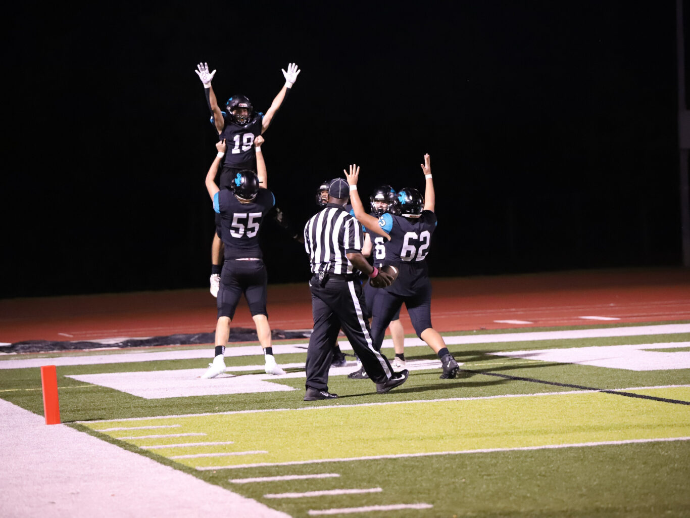 A group of football players celebrating a touchdown.