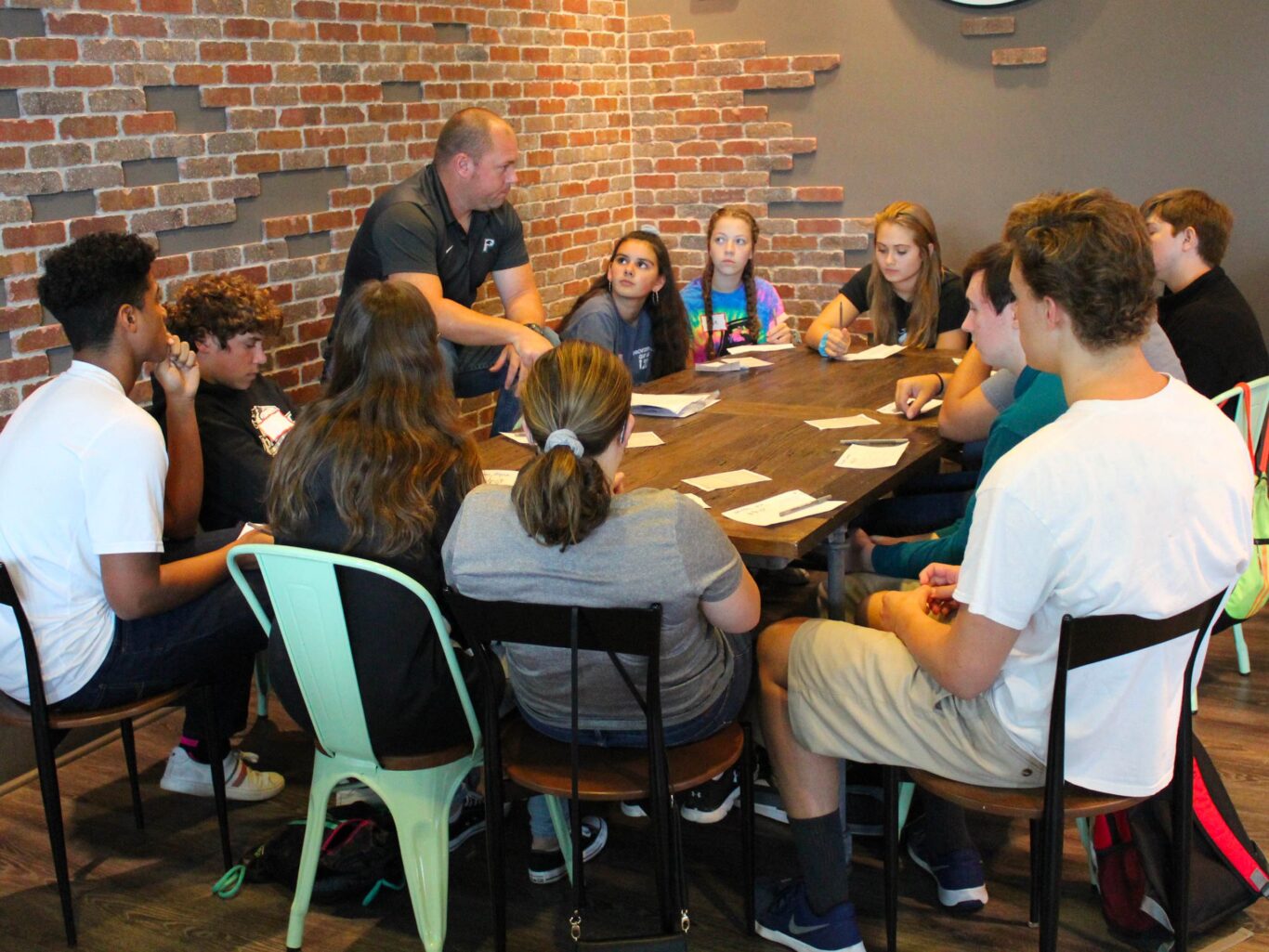 A group of people sitting about a table.