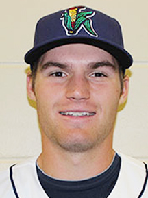 A college baseball player smiling for the camera.
