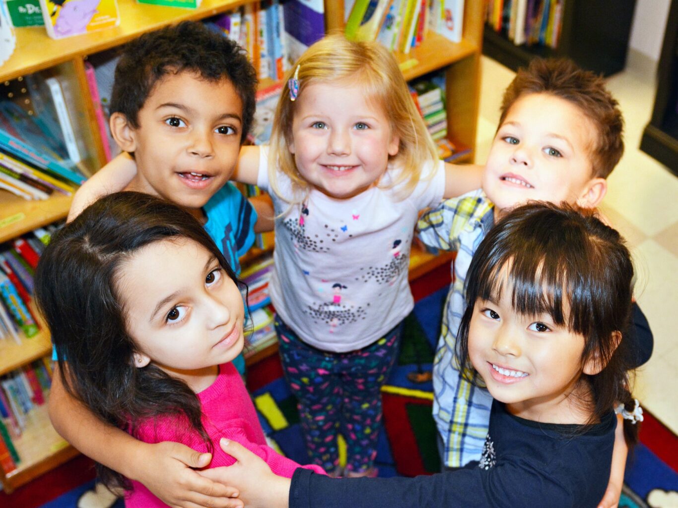 A group of children posing for a picture in a library, captured for the purpose of keywords and SEO optimization.