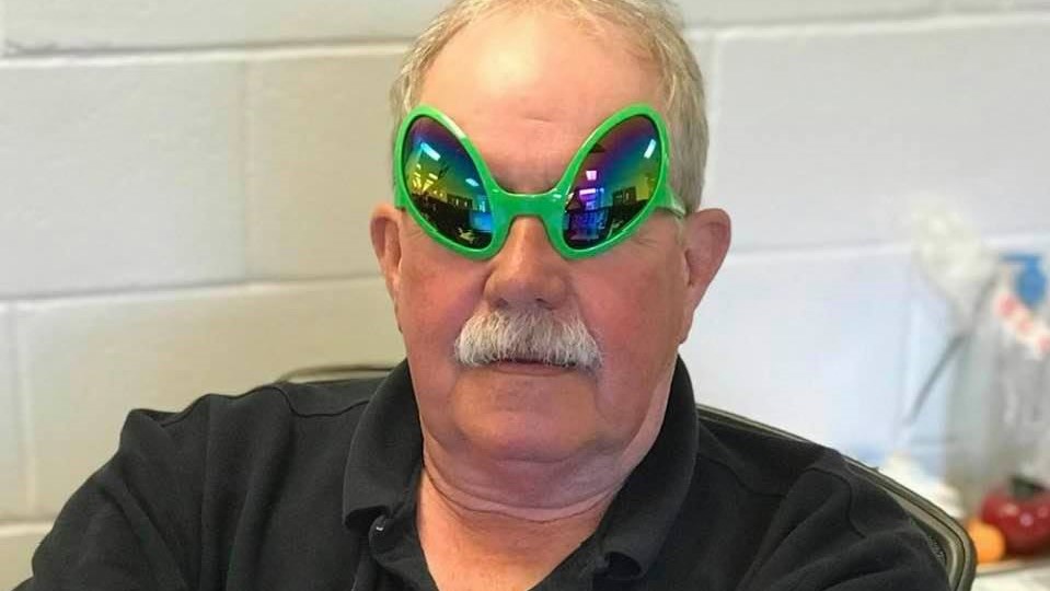 In loving memory of Mr. Larry, a man wearing green goggles and a mustache.