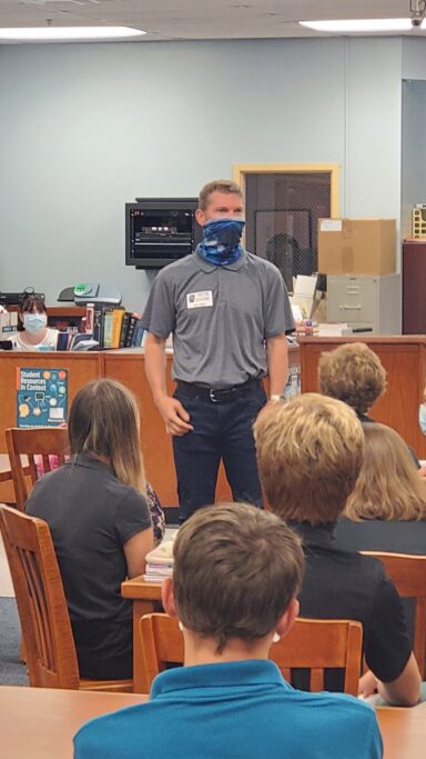 NY Times Bestselling Author, Charles Martin, visits Providence and stands in front of a group of people in a classroom.