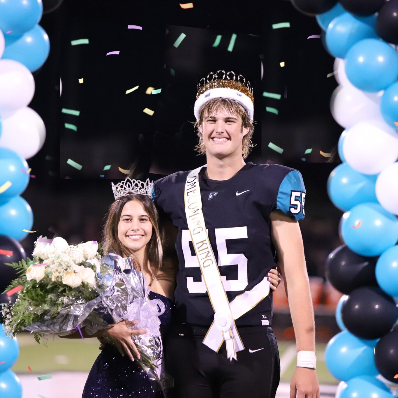 A football player and a girl posing for a picture at homecoming in 2023.