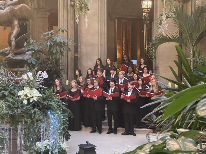 The Prov Chorale goes to Carnegie and performs in an ornate building, enchanting the audience with their captivating singing skills.