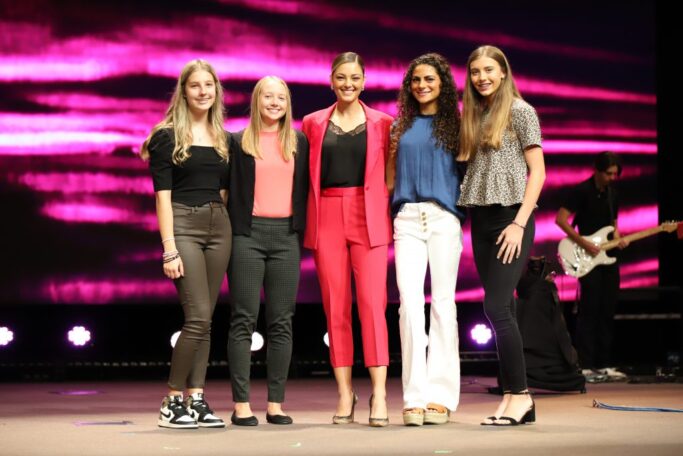 A group of women posing for a picture on stage at Special Chapel.