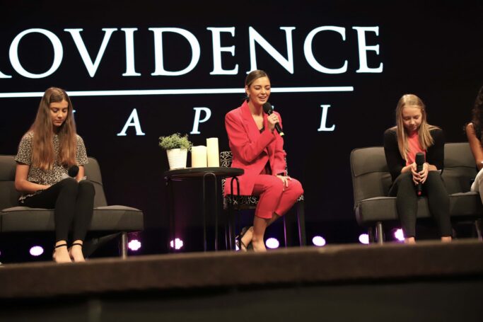 Demi Tebow and a special group of women on stage at the Providence conference chapel.