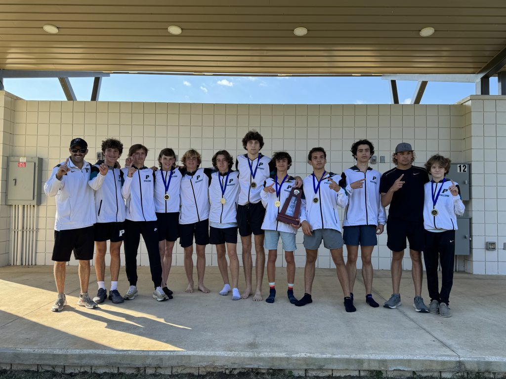 A group of boys and girls posing for a picture with their Cross Country medals.