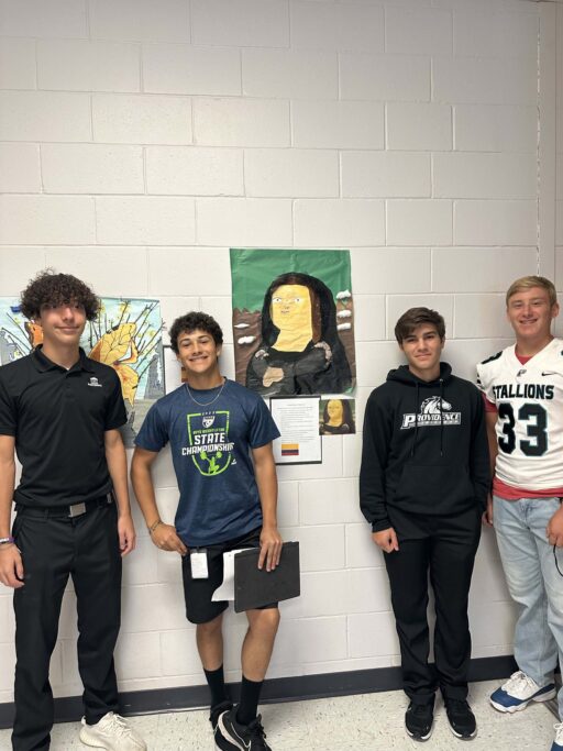 Four Spanish students standing in front of a wall with art on it, showcasing Hispanic culture.