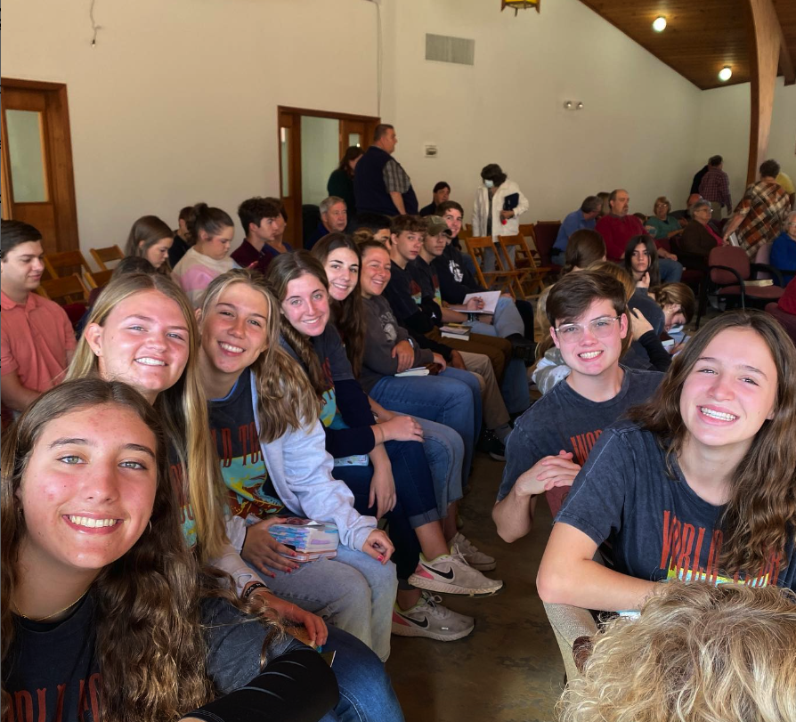 A group of people sitting in a church during a Missions Trip.