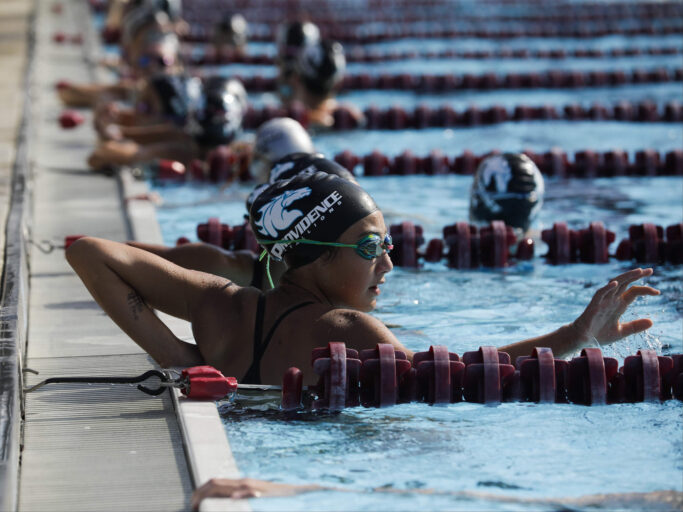 A group of girls swimming in a pool.