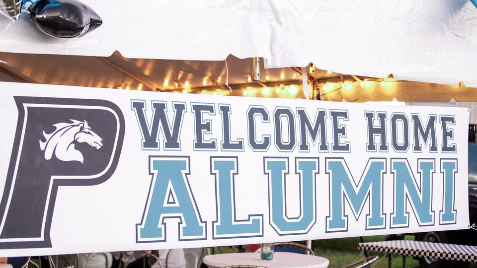 A 2023 homecoming banner with the words welcome home pallumni on it.