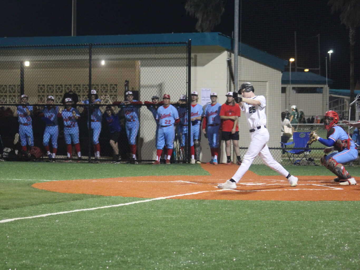 A baseball player swinging a bat at a pitch during a game.