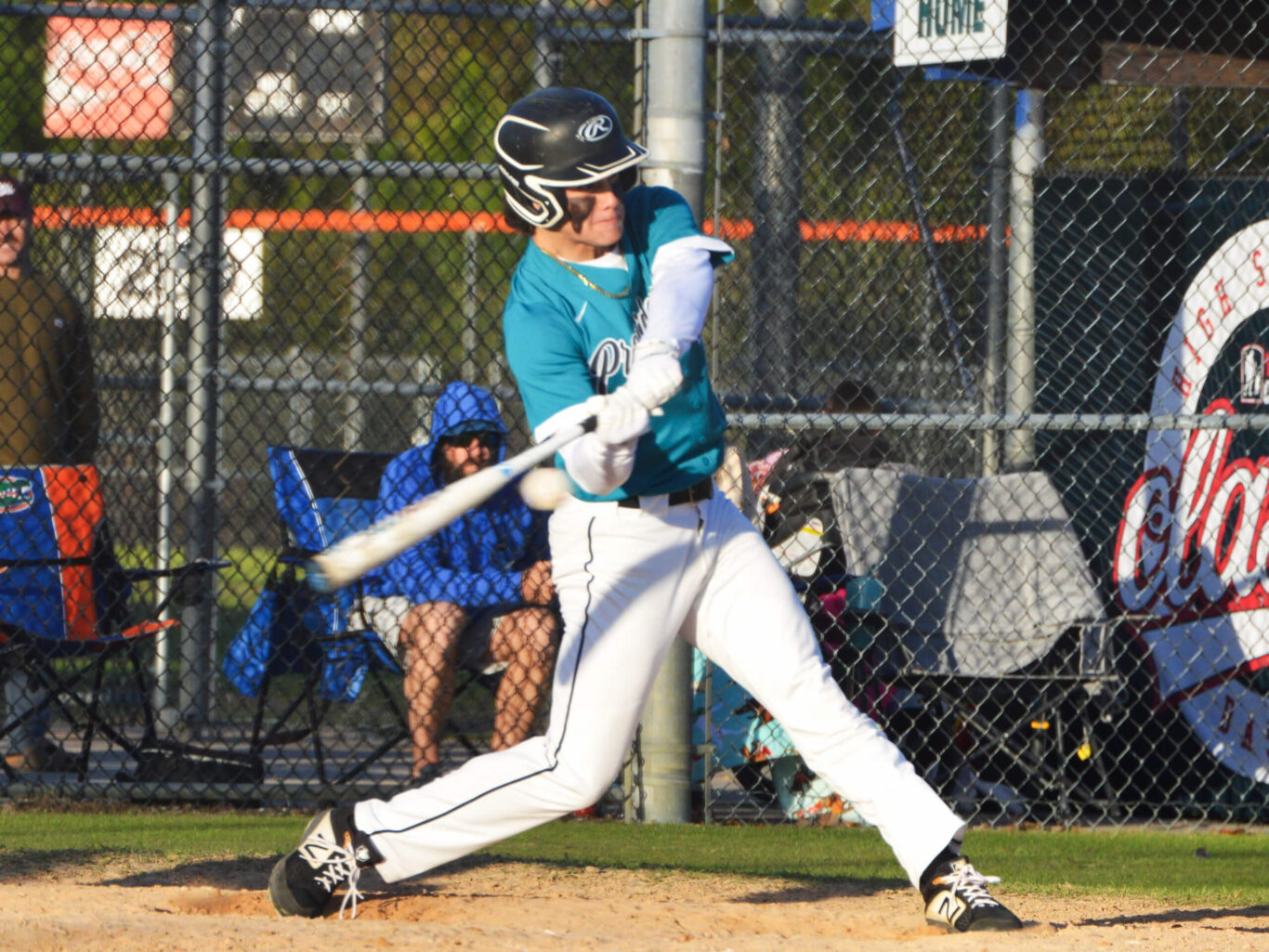 A baseball player powerfully swinging a bat.