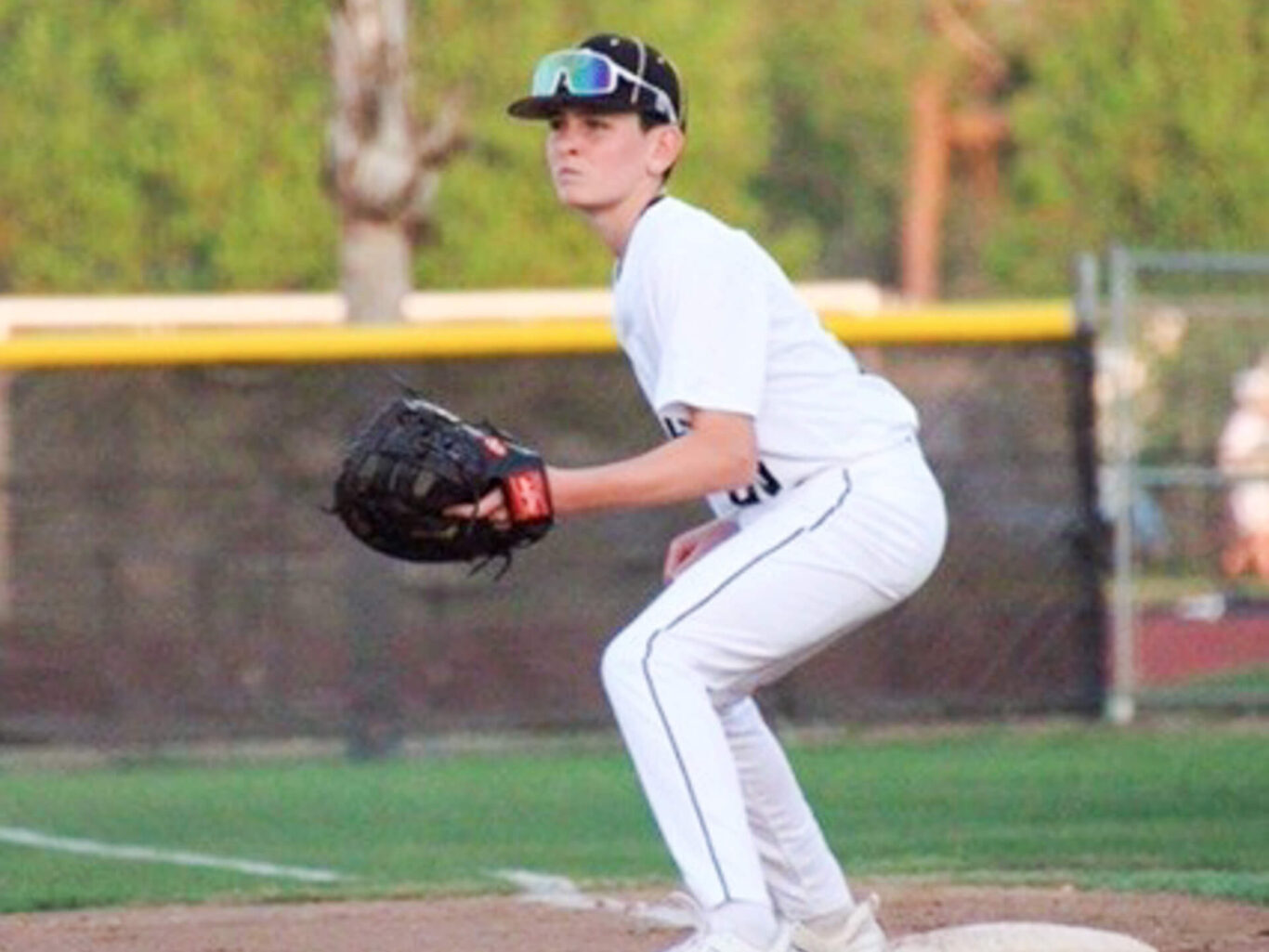 A baseball player is preparing to catch a ball during a game.