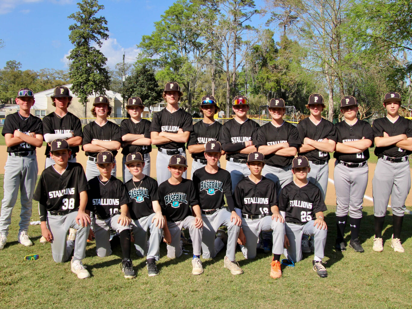 A baseball team is posing for a picture.
