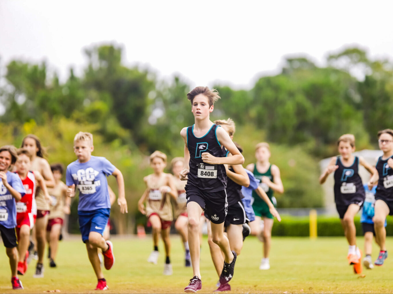 A group of boys competing in a cross country race.