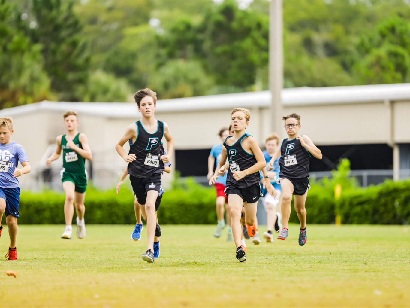 A cross country race featuring a group of boys.