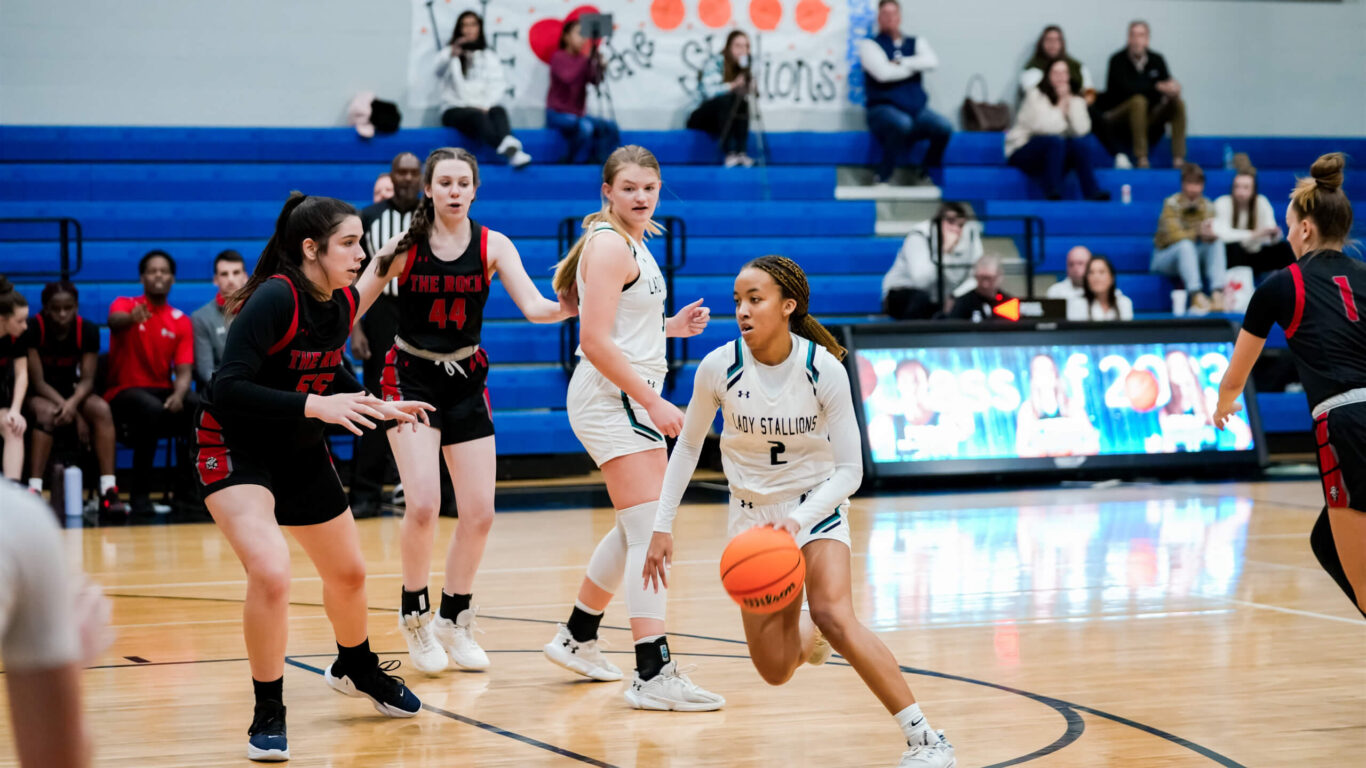 A group of girls playing basketball on a court.