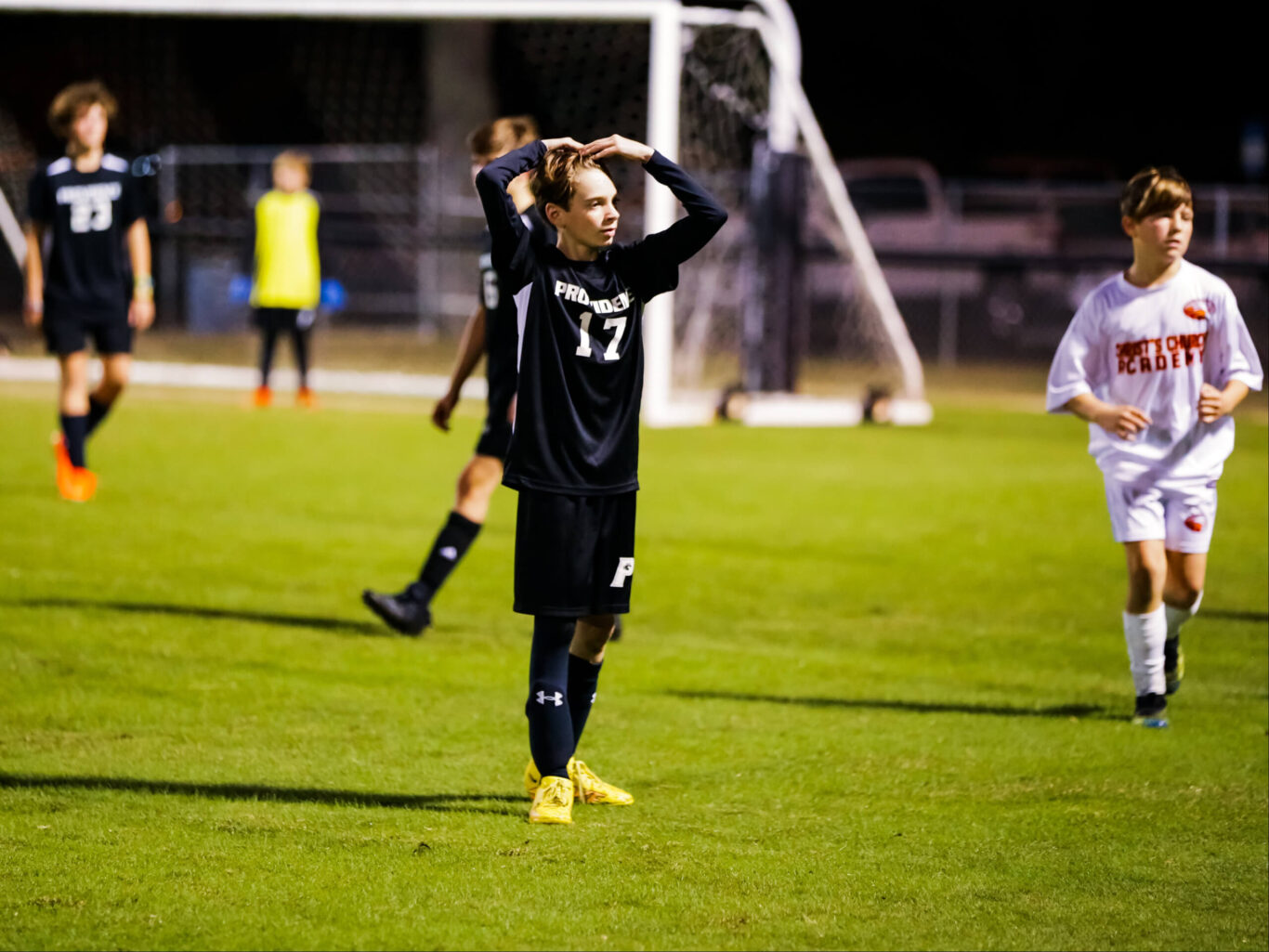A soccer player reacts to a goal during a game.