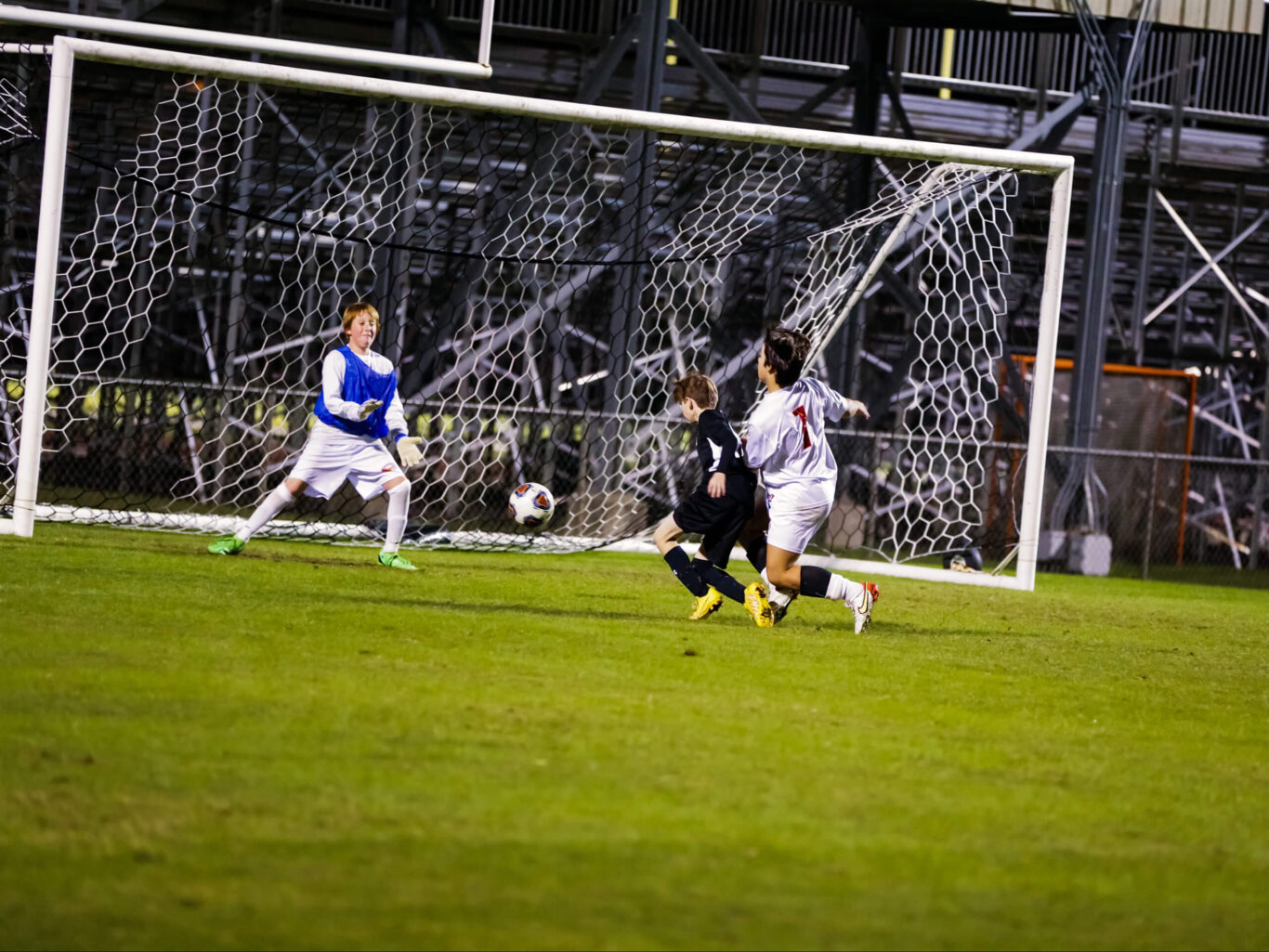 A group of boys playing soccer on a field.