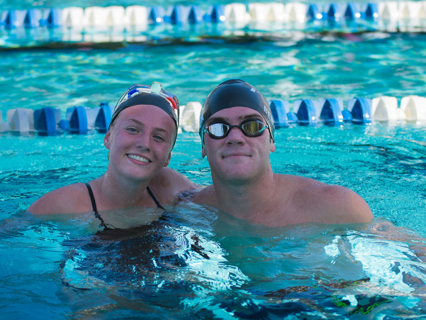 A couple enjoying a swim in a pool.