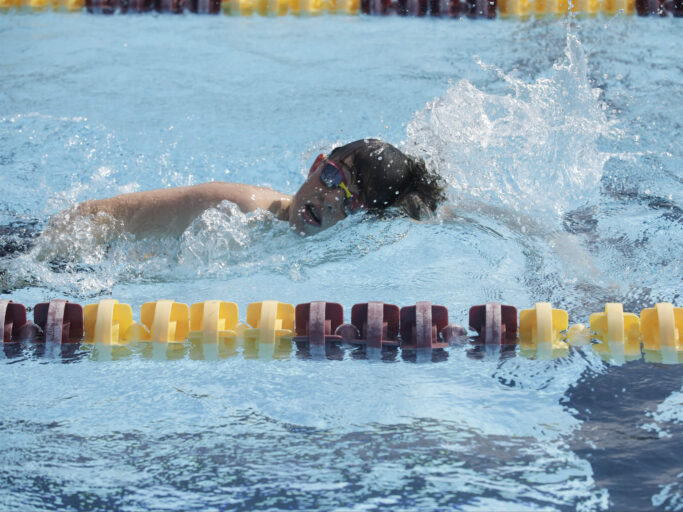 A boy swimming in a pool.