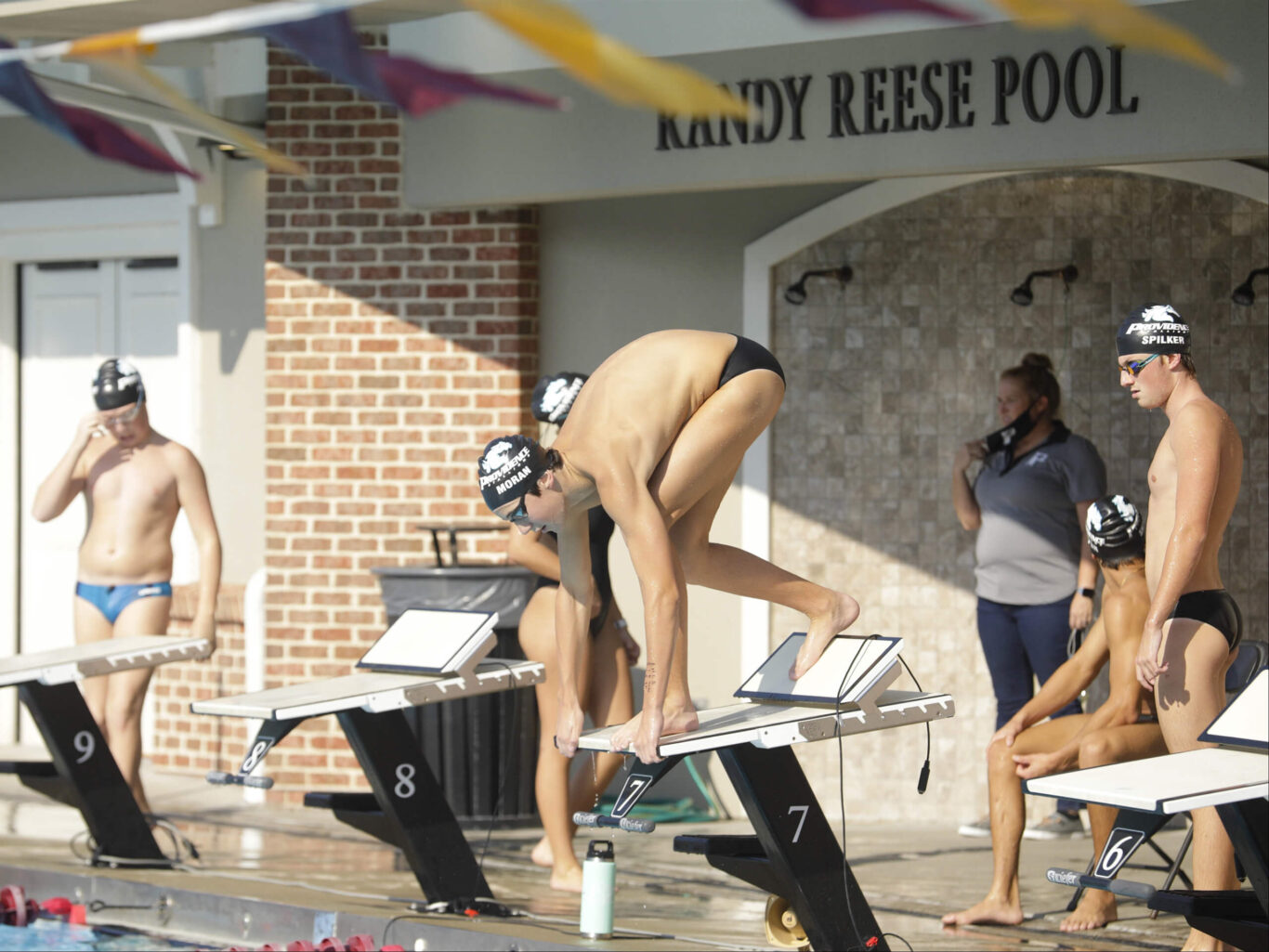 A group of boys swimming in a pool.