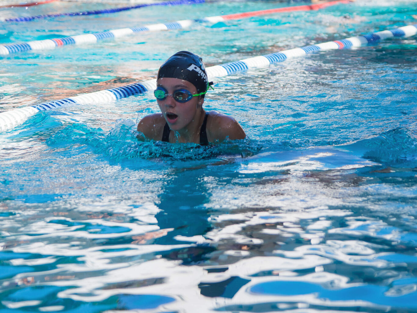 A girl swimming in a pool.