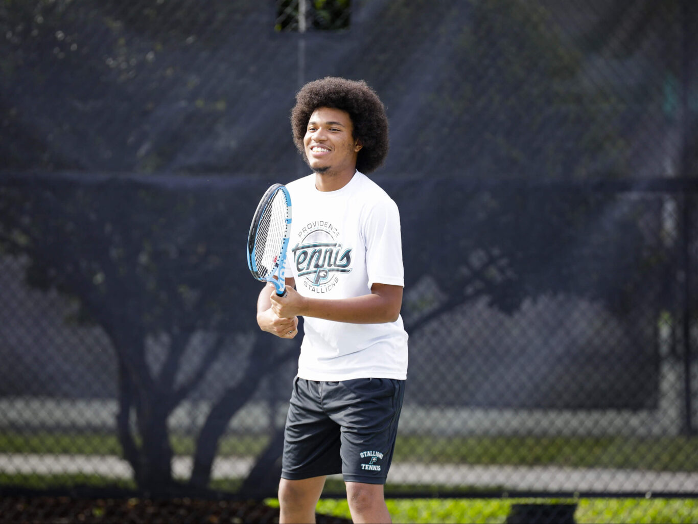 A man playing tennis on a tennis court.