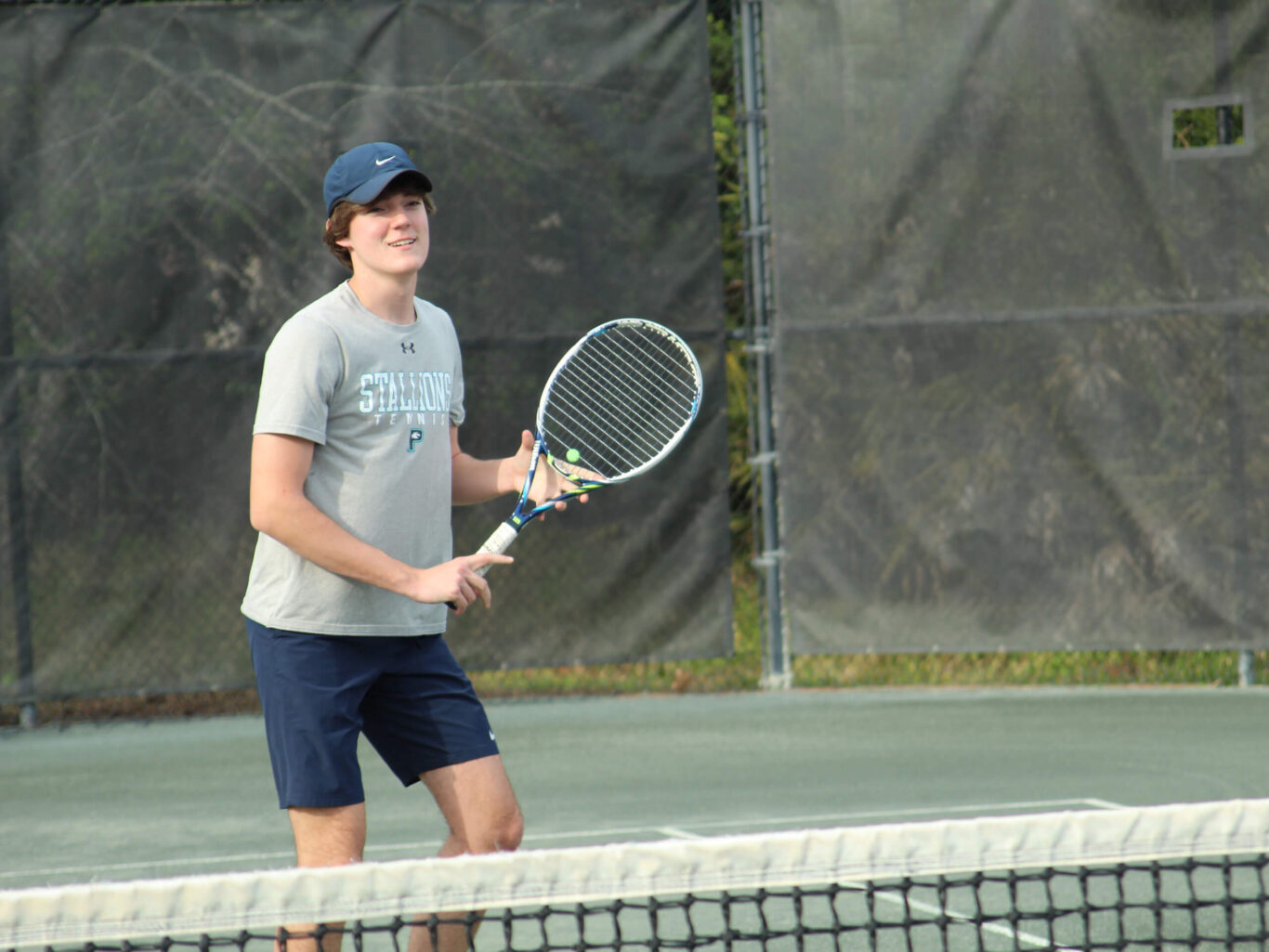 A man playing tennis on a tennis court.