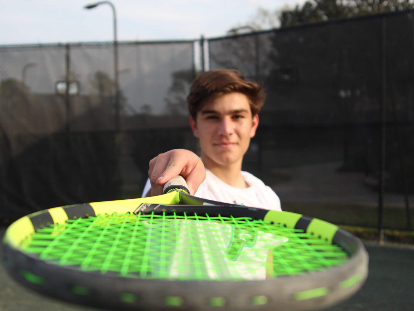 A boy holding a tennis racket.