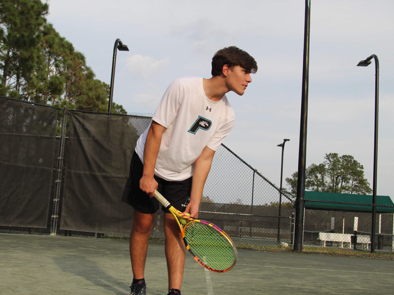 A man playing tennis on a court.