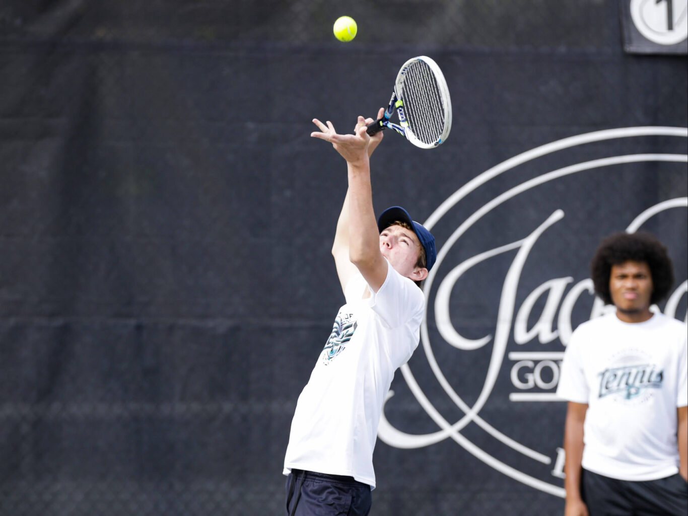 A man playing tennis with a tennis racket.