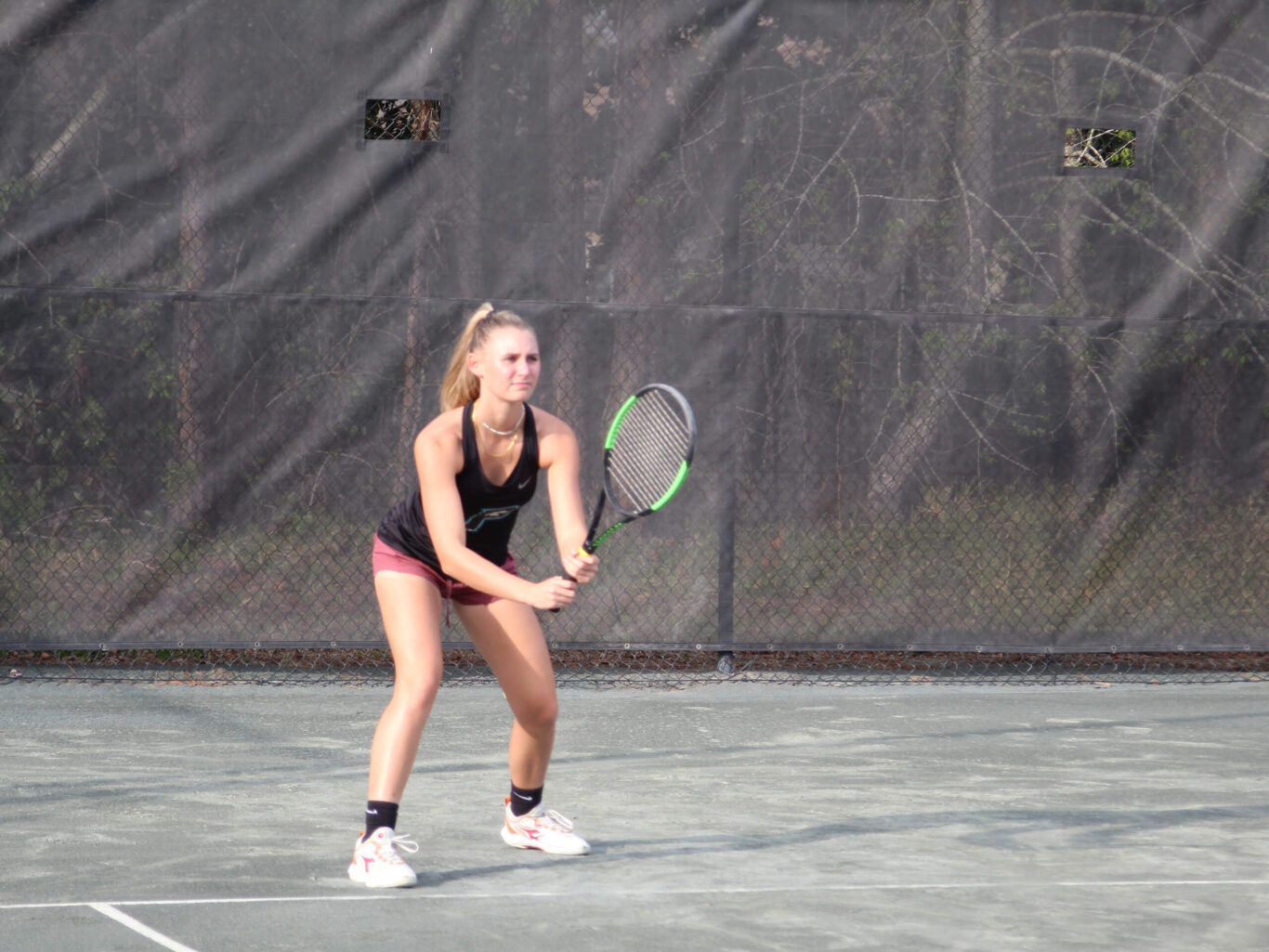 A girl playing tennis with a tennis racket