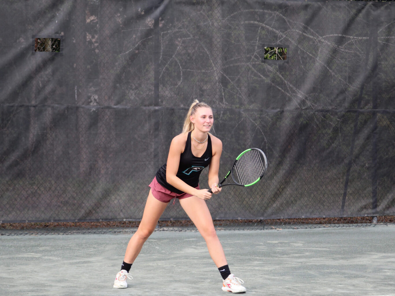 A Tennis Girl is holding a tennis racket.