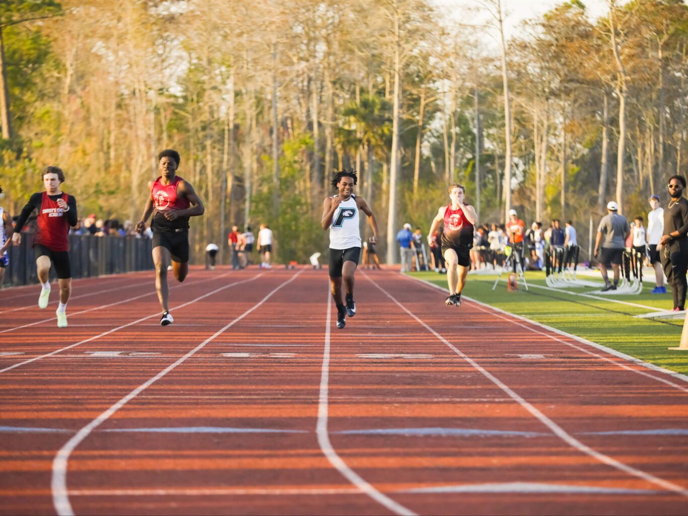 A group of boys competing in a Track and Field race.